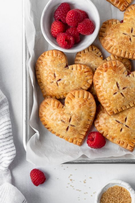 Raspberry Heart Hand Pies Heart Shaped Hand Pies, Mini Tart Pies, Raspberry Jam Puff Pastry, Apricot Hand Pies, Heart Hand Pies, Raspberry Hand Pies, Pastry Folding, Berry Hand Pies, Heart Tarts