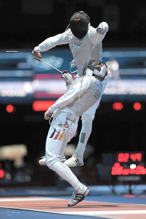 Fencing - London, 2012. I must say that fencing has become more of an "airborne" sport than was practiced when I was in my prime with the Italian foil. (I won a gold medal in a NY competition.) My father put an Italian foil in my hand at age 7 & told me that I was going to learn to fence! Period. This "flying through the air" was never seen at matches in my day. The balestra lunge was considered "flashy" & boy, was your face red when it backfired! Fencing Sport Photography, Fencing Aesthetic, Foil Fencing, Fencing Foil, Olympic Fencing, Fencing Sport, Black Fence, Small Fence, White Fence