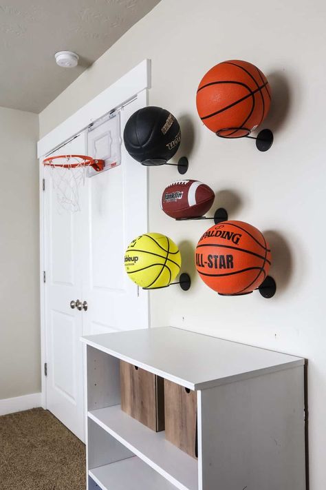 Soccer Storage Ideas, Baseball Card Wall Display Ideas, Sports Room Decoration, Baseball And Basketball Bedroom, Basketball Storage Ideas, Sports Themed Rooms For Boys, Sports Themed Playroom, Indoor Sports Room, Sports Game Room Ideas