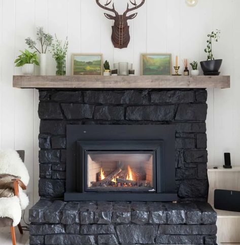 a large black stone clad fireplace with a wooden mantel is a great cabin or woodland touch to the space Black Stone Fireplace, Garage Bar Ideas, Modern Fireplaces, Wooden Mantel, Home Outdoor Decor, Black Fireplace, Home Restoration, Outdoor Decor Ideas, Garage Bar