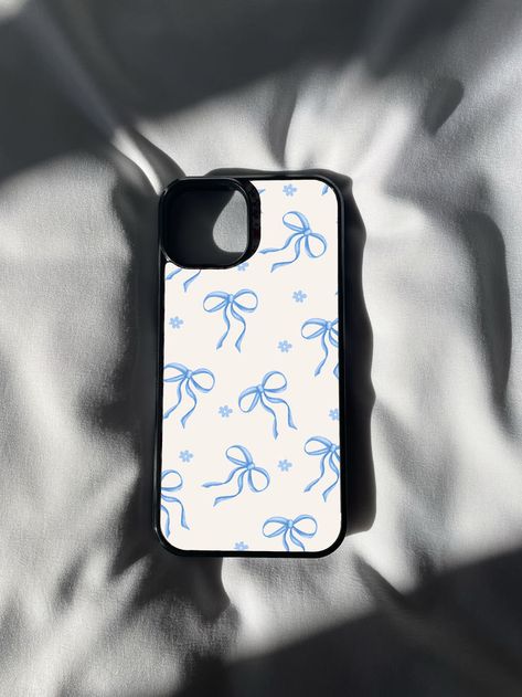 🎀💙 Elevate your phone style with our Blue Ribbon Print iPhone Case! 📱✨ Add a touch of timeless elegance to your device with this charming design featuring a delicate ribbon pattern in shades of blue. 💎🌟 Perfect for those who appreciate classic aesthetics and a touch of sophistication in their accessories. Whether you're heading to a special occasion or simply want to showcase your love for refined details, this case is the epitome of chic simplicity. 💙 Blue Case Aesthetic, Blue Ribbon Aesthetic, Ribbon Aesthetic, Phone Case Inspo, Coquette Phone Case, Ribbon Pattern, Print Iphone, Trendy Phone Cases, Blue Cases