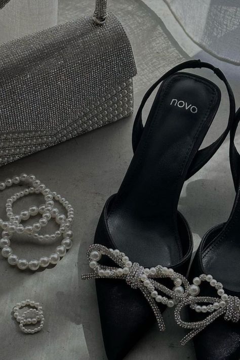 Talk about stepping into a world of chic! 😍 These black and white diamond and pearl shoes are total stunners that go with, well, EVERYTHING. 🖤🤍 From casual hangs to fancy soirées, they've got you covered. The perfect mix of classy and edgy, these shoes make a statement without even trying. To top it off Nova are having a Spend $80, Save $20, Spend $120, Save $30 deal until the 13th of August! Black Heels With Pearls, Pearl Heels Black, Black Fancy Shoes, Black Pearl Heels, Wine Heels, Black Dress With Pearls, Elegant Shoes Heels, Diamond Shoes, Black Satin Heels