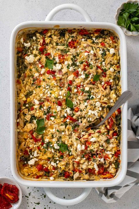 Filled with orzo, shredded chicken, and feta cheese, this one-pan Greek chicken casserole is an easy, healthy, and high-protein dinner idea. Greek Rice Casserole, Chicken Quinoa Casserole Recipes, Mediterranean Chicken Casserole, Healthy Casserole Recipes Clean Eating, Mediterranean Casserole Recipes, Greek Chicken Casserole, High Protein Casserole Recipes, Mediterranean Casserole, Greek Casserole