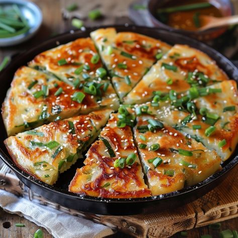 🥞 Enjoy the savory Pajeon (Green Onion Pancake)! 🌿✨ #Pajeon #KoreanPancake Pajeon (Green Onion Pancake) Ingredients: All-purpose flour (1 cup) Cold water (1 cup) Egg (1) Green onions, cut into 2-inch pieces (1 cup) Seafood mix (optional) (1/2 cup) Soy sauce (2 tbsp) Sesame oil (1 tbsp) Vegetable oil (for frying) Dipping sauce (soy sauce, vinegar, sesame seeds) Instructions: In a bowl, mix flour, water, egg, and soy sauce to form a batter. Stir in green onions and seafood mix (if using). H... Pancake Ingredients, Green Onion Pancake, Onion Pancake, Korean Pancake, Big Snacks, Seafood Mix, Instagram Recipes, Twisted Recipes, Savory Pancakes