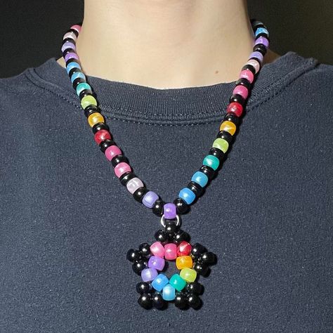 beaded necklace with kandi star charm + lobster claw clasp in back Kandi With Charms, Bead Ideas Crafts Diy Projects, Kandi Necklace Choker, Simple Kandi Cuff Ideas, Kandi Raver Outfits, Kandi With Perler, Scene Accessories Diy, Cool Kandi Ideas, Cute Kandi Ideas