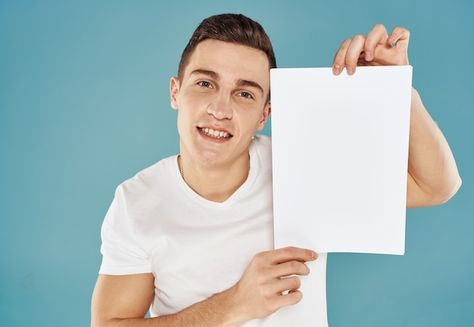 Young man holding a sheet of paper with ... | Premium Photo #Freepik #photo #holding-sign #holding-banner #holding-paper #business-executive Anime Holding Paper, Person Holding Paper Reference, Person Holding Sign, Man Holding Paper, Mtn Logo, Holding A Piece Of Paper, Holding Sign, Holding Paper, Man Pictures