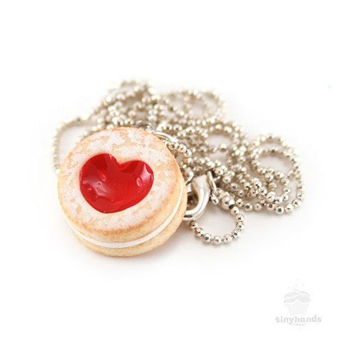 Size: 18 inch silver plated ballchain, heart cookie is 5/8" wideMaterial: Polymer clay, gloss, silver plated findingsSmells like: Strawberry shortcake cookies Is food the language of love? If so, this adorable Scented Shortcake Heart Cookie Necklace speaks volumes! Forget the symbolism of a single red rose, this tiny cookie charm expresses romantic intention perfectly. Sweetened with a generous dusting of icing sugar, the sweet jam-filled center has been sculpted to form a beautiful heart – idea Shortcake Cookies, Strawberry Shortcake Cookies, Single Red Rose, Heart Cookie, Delicious Clean Eating, The Cardigans, Heart Shaped Cookies, Heart Cookies, Diy Crafts To Do