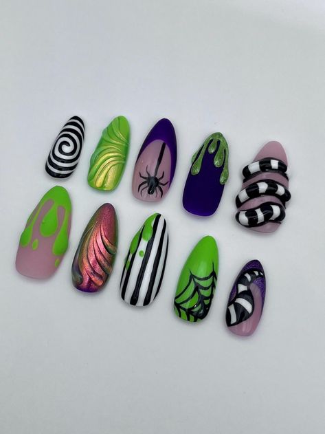 Beetlejuice inspired press on nails  Catch everyone's attention this Halloween with these mix-and-match, Beetlejuice nails (and just in time for the new movie 😉). From cat eye, to chrome, 3D and of course the Beetlejuice refrences, these nails will be perfect for your Halloween festivities. The base colour is customisable, with 7 different shades to pick from. (shade 6 is seen in photos) DISCLAIMER! All nails are hand painted so design and colours may differ slightly from pictures Hocos Pocos Nails, Beetlejuice Press On Nails, Hellraiser Nail Art, Mars Attacks Nails, Halloween Nail Designs Beetlejuice, Battle Juice Nails, Halloween Nails Movies, Beatleguese Nails, Halloween Nails Bettle Juice