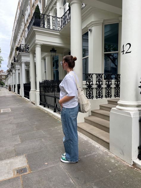 Young woman wearing a casual outfit with a white tee shirt, denim baggy jeans, and green adidas adimatic in the street of London Baggy Jeans Outfit, Last Dance, Light Blue Jeans, Baggy Pant, Jeans White, Jeans Outfit, White Tee, Baggy Jeans, White Top