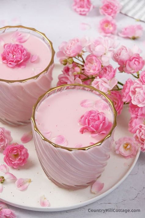 See how to make rose milk! Dreamy and delicious, rose milk is blended with milk, agave syrup, and rose essence and makes for an elegant, refreshing summer drink. This easy DIY rose milk recipe is made with natural, healthy ingredients. This romantic homemade rose flavored drink can be served chilled, iced or as a warm beverage. The post also talks about possible benefits and Includes variations for boba tea, lavender, strawberry, chocolate, and vanilla rose milk drink. | CountryHillCottage.com Rose Syrup Recipe, Rose Milk Tea, Rose Drink, Floral Drink, Yummy Summer Drinks, Easy Rose, Milk Benefits, Pastel Cupcakes, How To Make Rose