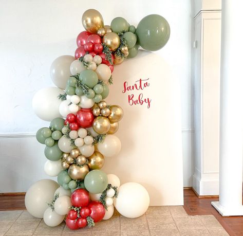 15 Best December Baby Shower Ideas - www.mummytries.com Christmas Gender Reveal Balloon Arch, Christmas Party Balloon Arch, Christmas Baby Shower Balloon Arch, Christmas Gender Reveal Decorations, Christmas Balloon Decoration, Christmas Baby Shower Backdrop, Christmas Arch Decor, Santa Baby Gender Reveal Ideas, Grinch Theme Baby Shower Ideas