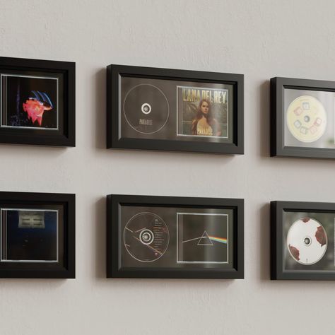 PRICES MAY VARY. 100% Wood + Plexiglass + EVA Board + Flocked Fabric Versatile CD Display Frame: Use this 7.7"x14.4" display frame to showcase your favorite CD cases, discs, and even signed memorabilia, designed specifically for music enthusiasts and collectors. High-Quality Construction: The frame features a durable wooden border, providing a sturdy and stylish foundation for displaying your CDs. It includes a luxurious black flocked fabric to enhance the presentation of your CD collection, off Music Frame, Cd Display, Cd Cases, Elegant Home Decor, Wall Ideas, Eva Foam, Fabric Wall, Solid Wood, Cd