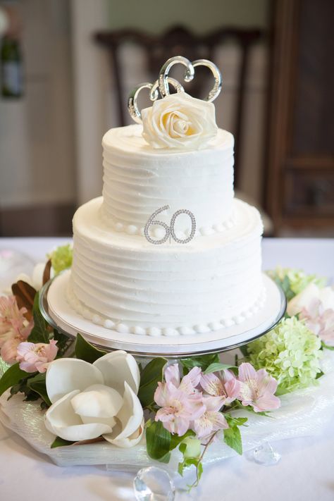 This is the cake we got for my parents anniversary party. Local bakery did the white double layered cake and I ordered the 60 and hearts off Amazon and added them and flowers on a yard of shiny fabric around the glass pedestal cake plate along with big diamonds scattered around the table to complete the look. 60th Anniversary Cake Ideas, Diamond Cake Ideas, 36 Anniversary, 60th Wedding Anniversary Decorations, Anniversary Cake Pictures, 60 Wedding Anniversary Cake, 60th Wedding Anniversary Party, 60th Anniversary Parties, Diamond Cake