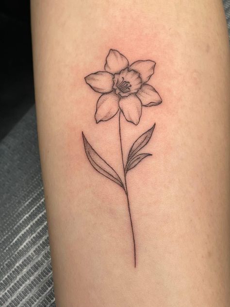 Tattoo ideas female Hand Tattoo | tattoo ideas by  Devon Ray Daffodil Name Stem Tattoo, Dainty Daffodil Tattoo With Name, Forearm Daffodil Tattoo, Daffodil With Bee Tattoo, Daffodil Tattoo Forearm, Small Dafodill Tattoo, Lilly And Daffodil Tattoo, Dainty Daffodil Tattoo Design, Daffodil Tattoo Leg