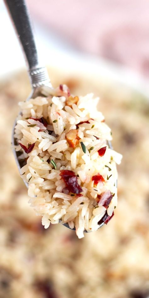 This Cranberry Rice Recipe is one of our favorite rice recipes—perfect for busy weeknights and fancy enough for holiday feasts. With fluffy rice, sweet dried cranberries, and a sprinkle of fresh thyme, it's bursting with flavor. The onion and garlic bring a savory twist, while the cranberries add just the right amount of sweetness.Best of all, whether you’re cooking it up in the Instant Pot or on the stovetop, you can have this dish ready in less than 30 minutes Rosemary Rice Recipes, Recipes With Dried Cranberries, Cranberry Wild Rice, Craisins Recipes, Cranberry Rice, Dried Cranberries Recipes, Quick Easy Side Dishes, Christmas Rice, Side Dishes For Ham