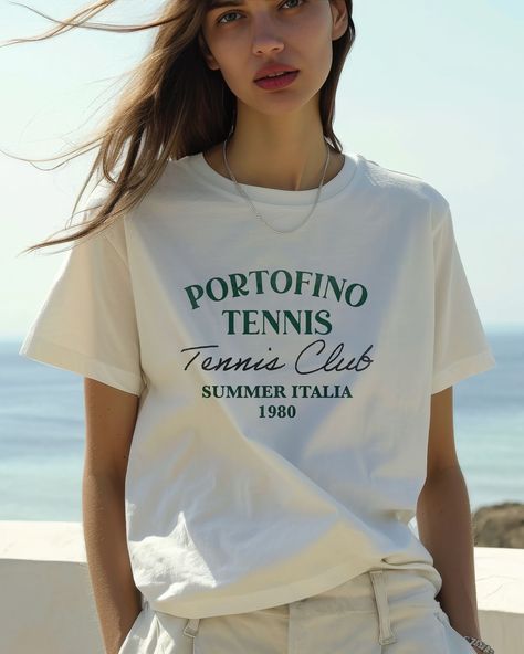 Join the Portofino Tennis Club. Zero tennis skills required. Suit up in our vintage tee and own the court like it's 1980 - sweatbands optional, but highly recommended for full retro effect. . . . . #VintageTee#Portofino1980#TennisStyle#EtsyGraphicTees#RetroFashion#CasualChic#EtsyTrendsetters#SummerItaliaTees#ClassicSportswear#EtsyVintageShop#FashionAce#ServeInStyle Italy Graphic, Portofino Italy, Retro Sports, Tennis Club, Tennis Clubs, Ciao Bella, Sporty And Rich, Vacation Travel, 로고 디자인