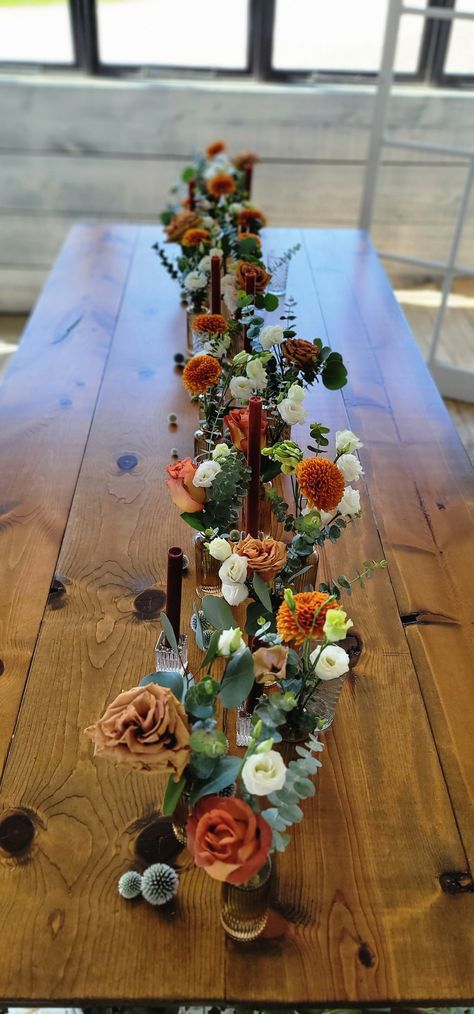 Eucalyptus Fall Wedding Table Decor, Fall Flower Bud Vase, Bud Vase Table Arrangements, Small Vases With Flowers Fall, Amber Glass Fall Centerpiece, Fall Wedding Harvest Table, Garland And Bud Vase Centerpiece, Fall Wedding Centerpieces Rectangle Tables, Fall Garden Wedding Table Decor