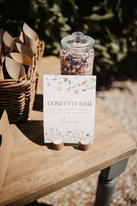 Confetti bar with clear jug filled with dried confetti on wooden table