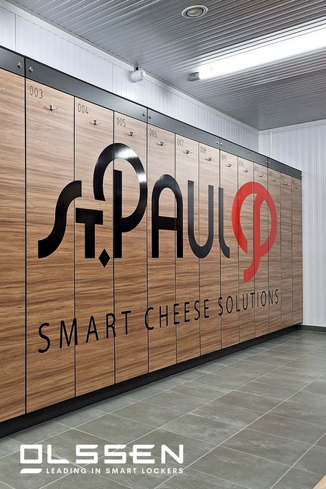 We installed these wooden dressing room lockers at St Paul's in Hulst. St. Paul is a cheese production company. Production workers use the locker room to change their personal clothes for work clothes.   The lockers are equipped with the Keynius smartlocking system. With their staff tag, employees can reserve and open a locker.  The company wanted to customise the lockers with their company branding. We provided and placed the stickers. Wooden Lockers, Production Company, Locker Room, Company Branding, Dressing Room, Storage Furniture, Lockers, Work Outfit, Custom Design