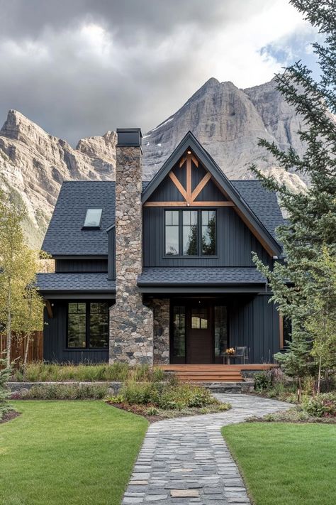 Check out the trending exterior colors for modern mountain houses that blend harmoniously with natural surroundings while adding a touch of contemporary flair. Black Mountain House Exterior, Mountain Home Entry Door, Airbnb Mountain House, House Rock Exterior, Mountain Chalet Exterior Colors, Dark House Wood Accents, Farmhouse With Rock Exterior, Chimney On Front Of House, House Colors Exterior Dark