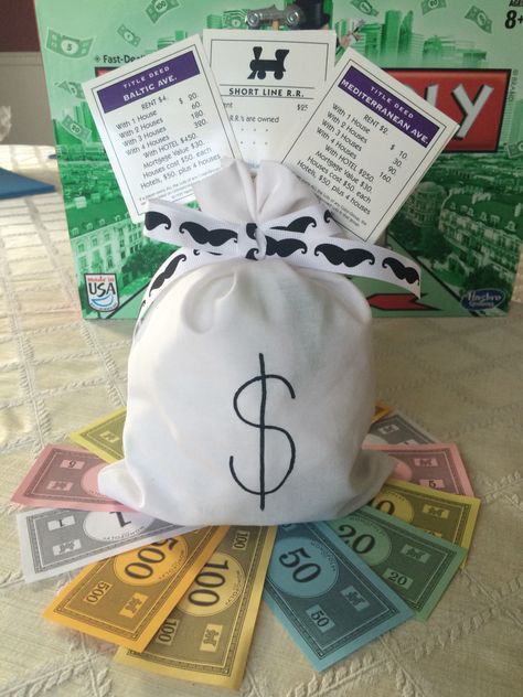 Monopoly centerpiece by my sister-in-law for my brother's 40th birthday party - picture only: half ball styrofoam and stuffing inside bag, mustache-themed ribbon, Monopoly game cards with game piece hot glued to dowel, sitting on fan of Monopoly money Monopoly Party Theme, Monopoly Birthday Party Ideas, Monopoly Birthday Party, Monopoly Centerpiece, Board Game Party Theme Decor, Monopoly Themed Party Decor, Monopoly Party Ideas, Board Game Theme Party, Monopoly Themed Party