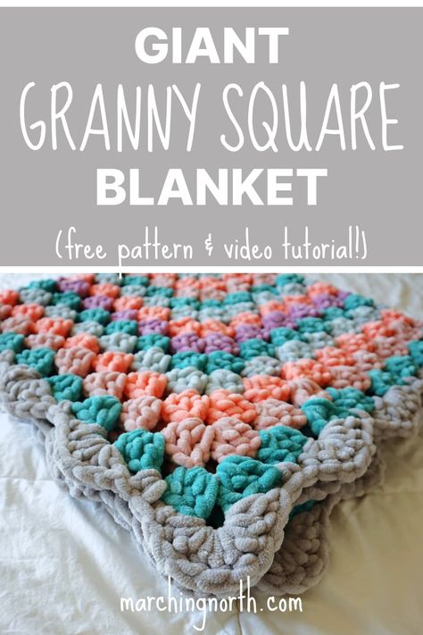 a colorful crochet granny square blanket folded on top of a white bed Quick And Easy Crochet Afgans, Fast Crochet Blanket Chunky, Crochet Blanket Patterns Fast, Granny Square Blanket Continuous, Granny Square Bubble Stitch, Soft Granny Square Blanket, Fluffy Yarn Granny Square, Crochet Fast Baby Blanket, Endless Granny Square Crochet Pattern