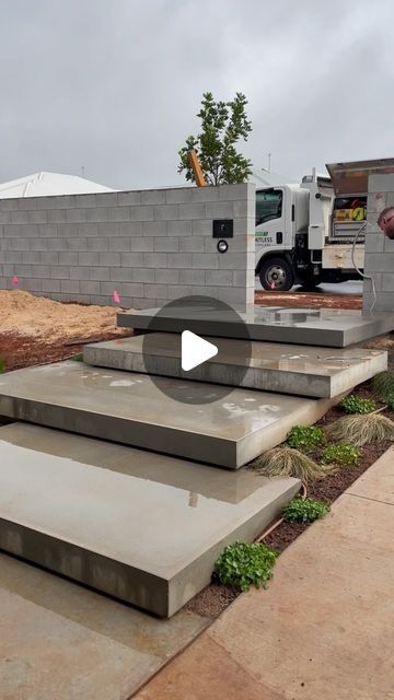 Limitless Queensland on Instagram: "Unboxing the final floating step for this project…featuring some soggy socks (there’s no way we were getting mud on these fresh steps).   Two @designertrees_ will be craned into place soon… can you guess what they’ll be? Here’s a hint: 💙🖤" Front Porch Step Design, Floating Concrete Steps Front Door, Modern Concrete Front Steps, Exterior Floating Stairs, Non Slip Outdoor Steps, Front Deck Steps, Floating Front Steps, Floating Concrete Steps Outdoor, Floating Steps Outdoor Entrance