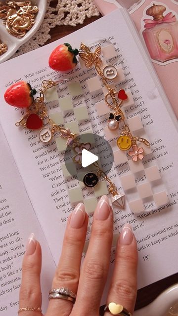 SAORI CALUYA DESIGN |  Artsy & Crafty on Instagram: "Materials 👇🏼❤️

- UV DTF bookmark decals & bookmark acrylic blank is available on our shop (link in bio 🫶) 
- chain: 3x7.5 mm gold chain (Amazon)
- strawberry charm (Amazon) 
- bunch of charms (i got 350pc charm bundle, Amazon) 
- initial charm (also from Amazon) 

All amazon items are in my storefront > “ Crafting Tools & Supplies “❤️❤️ 

#diygift #diybookmark #bffgoals #dateideas #crafting #craftymoms #charmbracelets #booklover" Charm Diy Craft Ideas, Acrylic Bookmarks Diy, Cricut Bookmark Ideas, Bookmark Charms, Charm Crafts, Bookmark Acrylic, Caluya Design, Craft Nights, Amazon Items