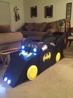 Cardboard box cart - Batmobile, yes the steering wheel turns. Cardboard Box Vehicles, Box Car Ideas Cardboard, Drive In Movie Box Car For Kids, Car Box Ideas, Cardboard Batmobile, Cardboard Cars For Kids Drive In, Kindy 500 Cars Cardboard Boxes, Box Car Ideas, Cardboard Box Cars