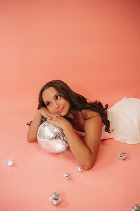 NYE disco ball, senior session at studio with pink backdrop portrait session Disco Ball Senior Photos, Disco Ball Prop Photography, Pink Disco Ball Photoshoot, Disco Ball Photoshoot Photography, Poses With Disco Ball, Disco Ball Studio Photoshoot, 21st Birthday Studio Photoshoot, Pink Disco Photoshoot, Disco Ball Portrait