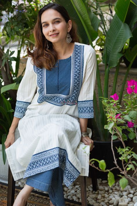 Tailored out of 100% premium cotton, Kalamala is a vibrant choice for your wardrobe for this summer. The unique dobbby print with universally flattering straight kurta is lit up with intricate Indigo border and stripes yoke with border on sleeves. The 3/4th sleeves, functional pocket in pants, and elegant round neckline with a tiny V cut make it a graceful choice for everyday wear. The set is complete with a stripe matching salwar that exudes smart chicness. Skater Design, Kurta Patterns, Kurta Pant Set, Simple Kurta Designs, Kurti Patterns, Salwar Designs, Kurti Designs Latest, Long Kurti Designs, Kurta Neck Design