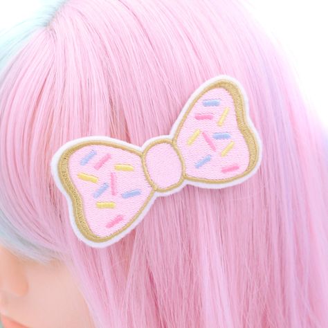 Indulge your sweet tooth with our Super Cute Doughnut Bow Hair Clip! This adorable hair clip features a doughnut-shaped bow adorned with pink icing and colorful sprinkles, all meticulously embroidered using the highest quality threads. Each detail is hand-drawn and digitized by me, ensuring a delightful and mouth-watering accessory. Handmade with love in the USA, this doughnut bow hair clip is perfect for pastry lovers and those who appreciate whimsical accessories. Whether you're grabbing coffee with friends, attending a brunch, or just want to add a touch of sweetness to your outfit, this hair clip is sure to make you smile. Complete with a metal hair clip sewn to the back, this doughnut bow clip is easy to attach and secure in place. Elevate your style with this handmade accessory, lovi Cutecore Hair Clips, Pink Kidcore Aesthetic, Cutecore Accessories, Cute Accessories Kawaii, Cute Doughnut, Candy Accessories, Kawaii Hair Accessories, Donut Hair, Kawaii Hair Clips