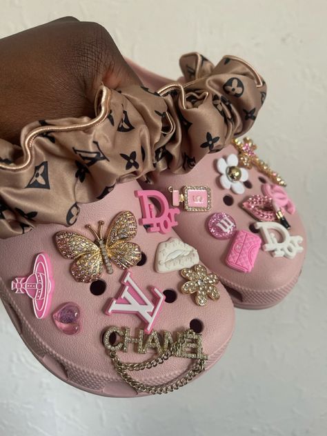 Pink custom crocs, boho, girly , jibbitz crocs, bling crocs, inspired crocs, croc charms #fashion #aesthetic #coquette #style Pink Crocs Aesthetic, Croc Inspiration, Cute Crocs Shoes, Croc Jibbitz Ideas, Dolphin Nails, Croc Ideas, Crocs Aesthetic, Graduation Gift Basket, Crocs With Charms