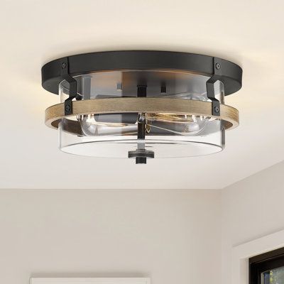 This 2-light flush mount light adds a mixed-material look to your space with its blend of metal and wood elements. It showcases a black iron frame paired with a brown wooden accent, so it's just right for any modern farmhouse space. The clear glass shade allows the light to shine through, creating an ambient glow in your room. This fixture accommodates two 60W bulbs (not included) and is dimmable, allowing you to adjust the brightness to your preference. Designed for dry locations, it's corrosio Black Flush Mount Light, Modern Flush Mount Ceiling Light, Wood Ceiling Lights, Entryway Lighting, Semi Flush Lighting, Light Fixtures Flush Mount, Farmhouse Lighting, Lighting Inspiration, Laurel Foundry Modern Farmhouse