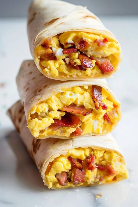 Loaded with fluffy, cheesy scrambled eggs and topped with perfectly crispy bacon, these bacon and egg breakfast wraps are comfort food at its best. Essen, Egg Bacon Breakfast Ideas, Bacon Egg And Cheese Breakfast Burrito, Breakfast Sale Ideas, Bacon Egg And Cheese Wrap, Breakfast With Eggs And Bacon, Easy Egg Breakfast Ideas, Egg Dishes For Breakfast, Bacon Breakfast Ideas