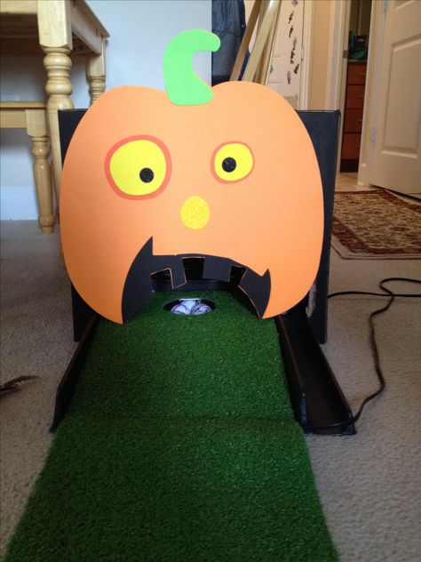 Halloween Putting Pumpkin.   Granddaughters are having a Halloween Birthday Party  so take a golf putting green, box painted black and go to Micheal's and get this foam  pumpkin and glue on front of box.  Set box over hole.  Have the ifs putt the golf ball in the pumpkins mouth.  I am using yellow golf balls. Pumpkin Golf Game, Mini Golf Trunk Or Treat, Pumpkin Putt Putt Golf, Halloween Putt Putt Golf, Halloween Mini Golf Diy, Golf Trunk Or Treat Ideas, Halloween Putt Putt, Pumpkin Putt Putt, Halloween Mini Golf