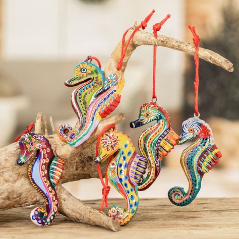 "When I was a little boy I loved everything that had to do with the sea and its creatures, especially seahorses. They are so morphologically different to the rest of the fish that I was fascinated by them. This childhood interest now inspires me to design these ornaments," confides José Arriola. The Guatemalan artisan handcrafts the ornaments of ceramic and paints each one with acrylics with different themes. The six ornaments hangs from bright red ribbons, and the set arrives in a traditional cotton pouch woven on a pedal-loom. Tiki Kitchen, Seahorse Ornament, Polymer Flowers, Clam Shells, Funny Earrings, Fish Ornaments, Fish Motif, Art Sea, Ceramic Techniques