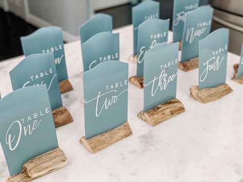 Wedding Table Decorations Beach Theme, Table Numbers Beach Wedding, Sea Glass Table Numbers, Seaglass Wedding Centerpieces, Beachy Wedding Centerpieces, Sea Glass Blue Wedding, Seaglass Wedding Decor, Blue Table Numbers Wedding, Sea Glass Wedding Colors