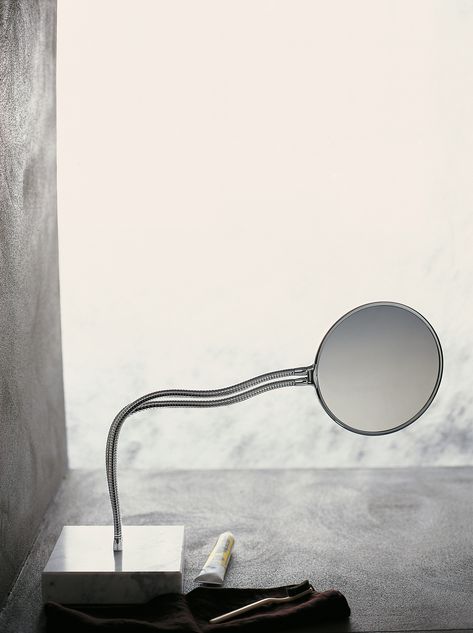 1997 - Design by Benedini Associati / / / The chrome-plated double flexible support allows Fusilli to be positioned at any angle. The mirror is double-sided, with one magnifying surface. Numerous installation options are available: on the wall, on a countertop, or free standing, using a square marble base, which adds a distinguished air. Element Lighting, Circular Mirror, Fire Clay, Magnifying Mirror, Standing Mirror, Shower Tray, Heating Element, Carrara Marble, The Mirror