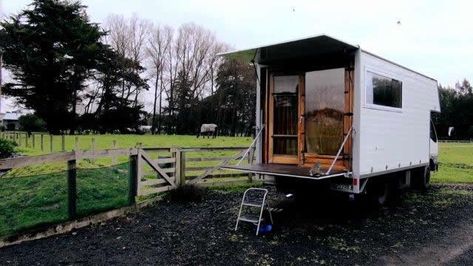 This is a story about living simply in a Tiny Housetruck Conversion. From the outside, you’ll a plain white box truck with windows and an interesting rear entrance. When you go inside, you&#8… Uhaul Truck, Small Truck Camper, Horse Box Conversion, Truck House, Diy Tiny House, Horse Box, Living Simply, Box Truck, Small Trucks