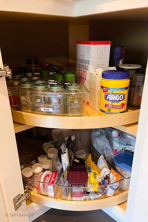 Organize your spices in a lazy susan cabinet for easy access, efficiency, and to make the most of your dried herbs and spices. Check out the steps, considerations and space saving methods to create your own well organized storage space. Spin Cabinet Organization, Spice Cabinet Lazy Susan, Spice Organization Corner Cabinet, Dry Herb Storage Ideas, Spice Organization Lazy Susan Corner Cabinets, What To Put In A Lazy Susan Cabinet, Spice Organization Lazy Susan, Organizing Lazy Susan Cabinet Kitchens, How To Organize Corner Kitchen Cabinet Lazy Susan