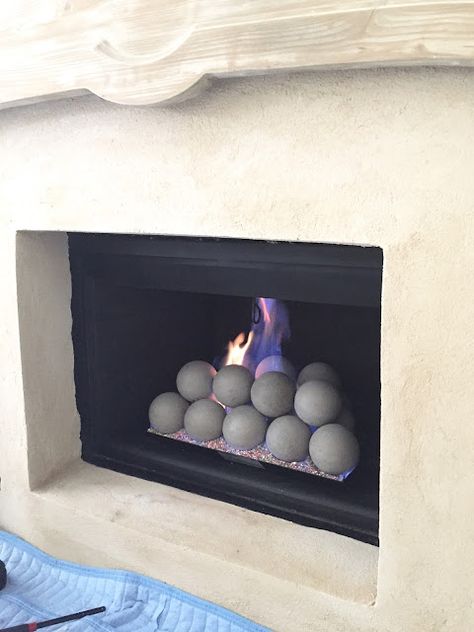 THIS AND THAT - design indulgence Gas Fireplace With Balls, Gas Fireplace Balls, Fireplace Balls Gas, Fireplace With Balls, Fireplace Balls, Ball Fireplace, Fireplaces Makeover Modern, Fire Glass Fireplace, Fireplace Styling