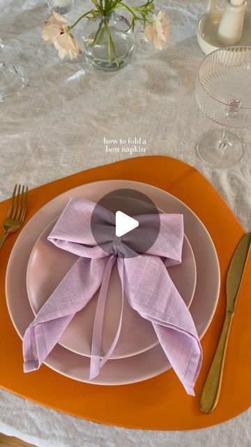 Ashley Tassano on Instagram: "I decided to add this bow napkin last minute, and I’m so happy I did. Not only was it simple, but everyone loved it! You could also make these with a napkin ring or a clear elastic instead of the ribbon.   Tip: Save the ribbon to use again or add it to glassware for your next event. ✨  #coquette #bows #napkinfolding #tablescapes #tablescapestyling #tablescapetuesday #discover" Tea Party Napkin Rings, Tying Napkins With Ribbon, Paper Napkin Bow, Now Napkin Fold, How To Fold A Napkin Into A Bow, Cute Napkin Folds Easy, Bow Napkin Wedding, Cute Ways To Fold Napkins, Napkins Tied With Ribbon