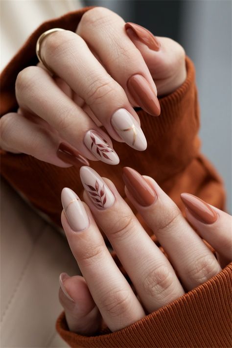 Embrace the essence of the season with these elegant autumn simple fall nail ideas that are effortlessly chic. Featuring muted tones of burnt orange and deep burgundy, this nail style encapsulates the warmth and beauty of autumn leaves. The addition of subtle gold accents brings just the right touch of glamour, making your nails the perfect accessory for any fall outfit. Dive into this seasonal delight and elevate your manicure game! Fall Drip Nails, Manicure Fall Nails, Autumn Nails Wedding, November Nails Short Almond, Simple Nail Ideas For Fall, Negative Space Nails Fall, Simple Fall Nail Designs Leaves, Fall Themed French Tip Nails, Leave Nails Fall