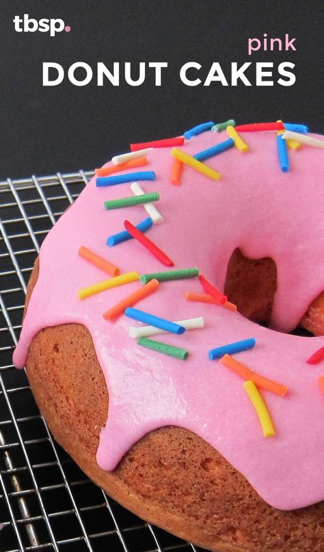 Two bright pink, glazed and donut-shaped strawberry cakes topped with sprinkles. For a show-stopping treat everyone will love, this recipe is a must-make! Donut Shaped Cake, Donut Cakes, 9th Birthday Cake, Glaze For Cake, Diy Donuts, Pink Donut, Holiday Tips, Birthday Breakfast, Doughnut Cake