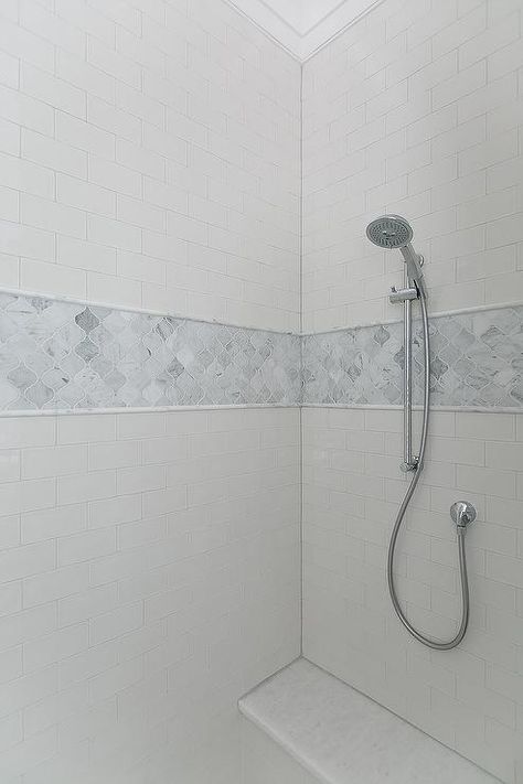 Marble arabesque shower tiles lined with gray marble pencil tiles accent a white subway tiled shower surround fitted with a polished nickel hand held shower head mounted over a marble bench. White Subway Tile Shower, Bathroom Tour, Gray Shower Tile, Marble Shower Tile, Bathroom Shower Stalls, Subway Tile Showers, Accent Tiles, Shower Tiles, Bedroom Addition