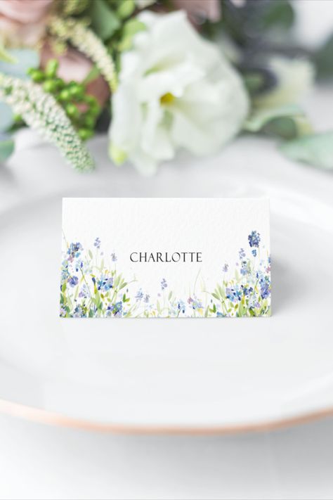 Blue and green forget me not Wildflower print tent fold place card printed on textured white card. Shown on a white plate with greenery in the background Blue Wildflower Wedding, Buffet Party Food, Japanese Theme Parties, Name Card Wedding, Name Cards Wedding, Place Name Cards, Place Setting Cards, Buffet Party, Wedding Place Names