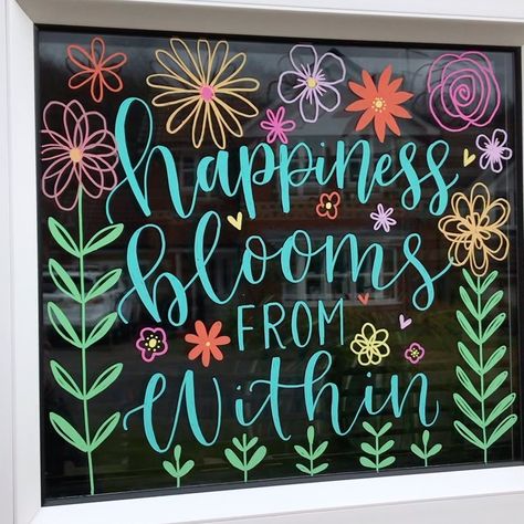 Nikki Whiston Inks on Instagram: ““Happiness blooms from within” New window painting done today to make all my neighbours & kids smile when they are out for fresh air! Also…” April Window Art, Window Painting Lettering, Spring Window Chalk Art, School Window Painting Ideas, Chalk Art Flowers Simple, Easy Spring Window Art, Spring Dry Erase Board Art, Floral Window Art, Spring Window Ideas