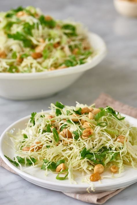 This crunchy cabbage and peanut slaw recipe makes for a great side dish because you only have to combine a few easy ingredients. The combo of cabbage, peanuts, and rice vinegar with oil is one you won't forget. Additional ingredients include fresh cilantro, salt and pepper, granulated sugar and soy sauce. Peanut Slaw Recipe, Peanut Slaw, Side Dishes For Salmon, Dinners Recipes, Quick Food, Easy Vegetarian Dinner, Slaw Recipes, Vegetarian Dinners, Roasted Peanuts