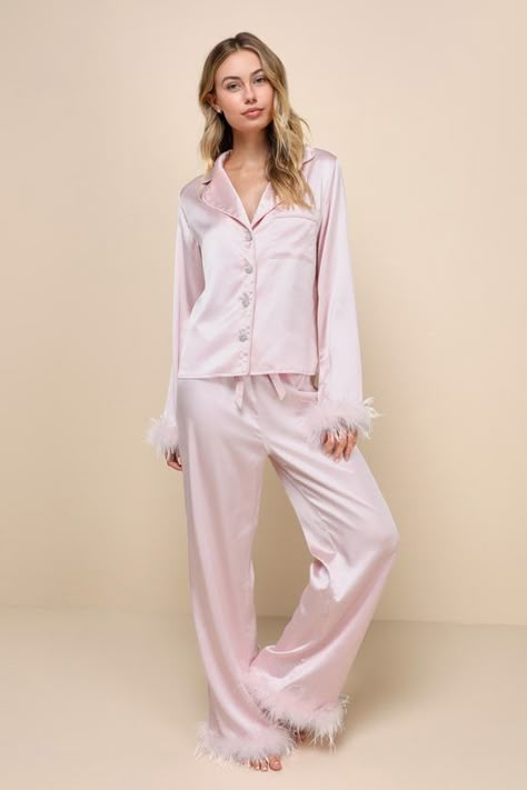 With the Lulus Dreamiest Delight Light Pink Satin Feather Two-Piece Pajama Set, you'll look so good that you'll never want to go to bed! This sleek pajama set has a sexy woven satin construction that shapes a collared neckline and long sleeves with fluffy, feather-trimmed cuffs. The relaxed, button-up bodice features dazzling, rhinestone-encrusted buttons and a front patch pocket. The matching bottoms boast a high elasticized waist with a cinching drawstring tie, that tops straight pant legs ... Feather Pajamas Aesthetic, Fur Pajama Set, Silk Feather Pajamas, Feather Trim Pajamas, Pink Silk Pajamas Aesthetic, Silk Pink Pajamas, Feather Pajama Set, Light Pink Accessories, Glam Pajamas